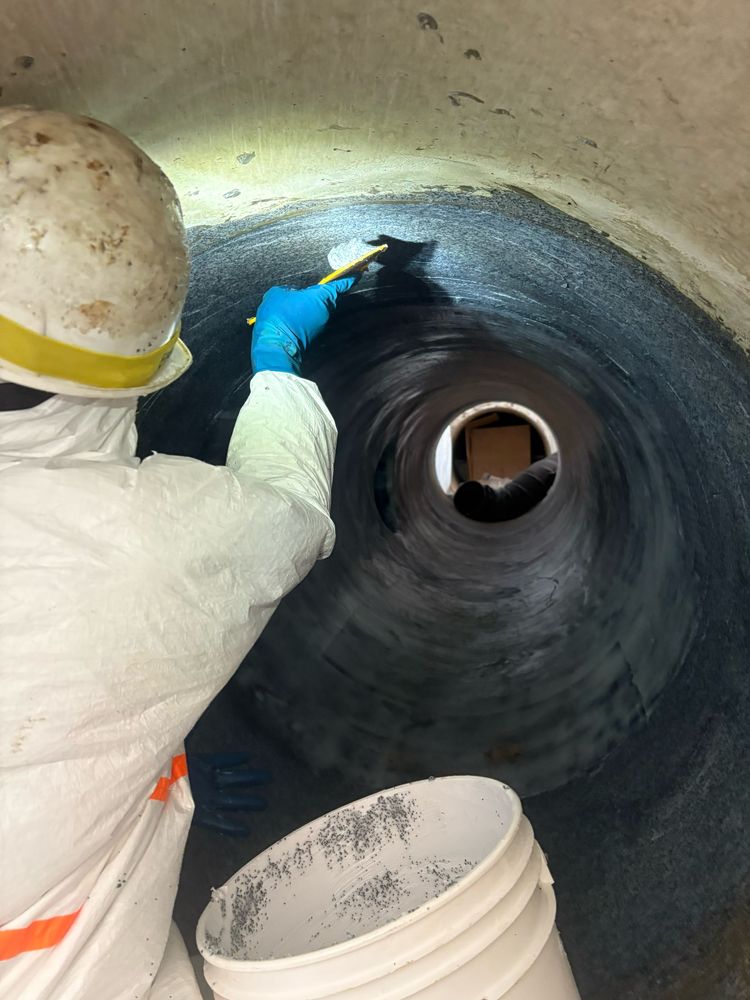 Crew working inside a large-diameter pipe section