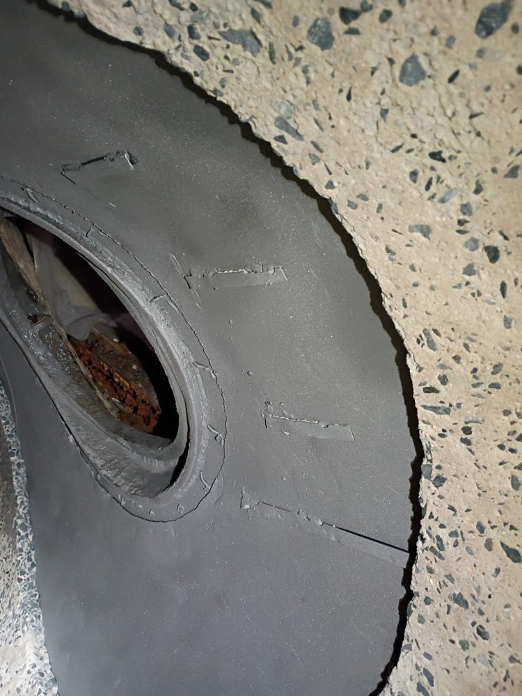Corroded steel encapsulated and prepared for carbon-fiber strengthening